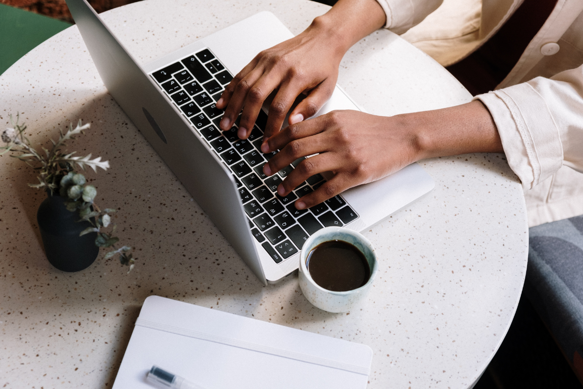 Woman typing on a computer. About Us, Consultation Image.